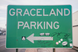 A graffitied sign for Graceland Parking on Elvis Presley Boulevard. (Brandon Dahlberg)