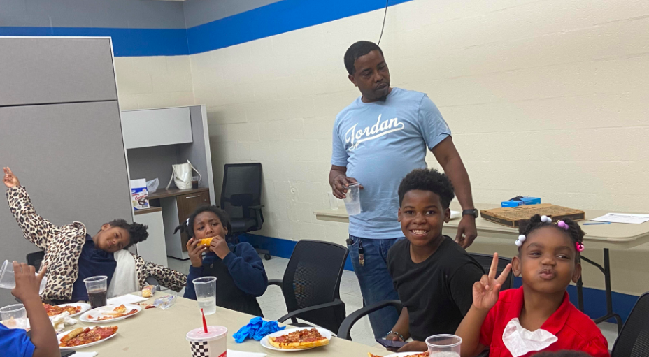 Casio Montez checks in with a group of children during lunch.