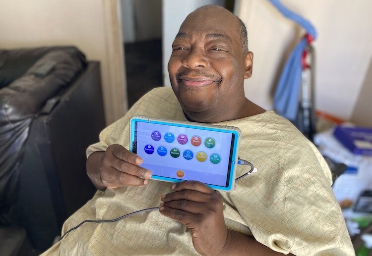 Anthony Walker with his Claris tablet that helps him stay connected.