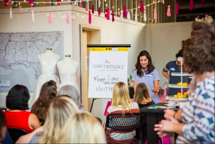 Dorothy Collier introduces Molly Farrell of Maggie Louise Bridal at an August meeting of the Rising Tide Society. (Kristen Archer)