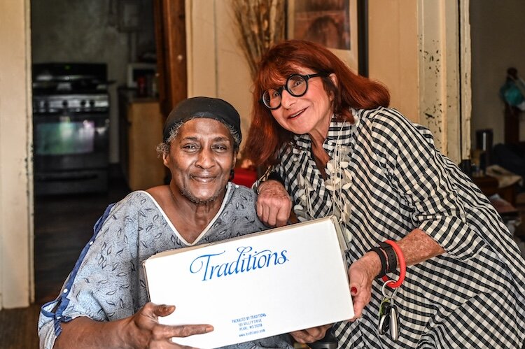 Sharon Pollion receives a frozen box from volunteer Jody Becker.