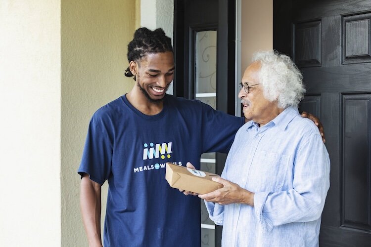 A Meals on Wheels Volunteer with a client. Meals on Wheels America is working with MIFA in a program called End the Wait. 